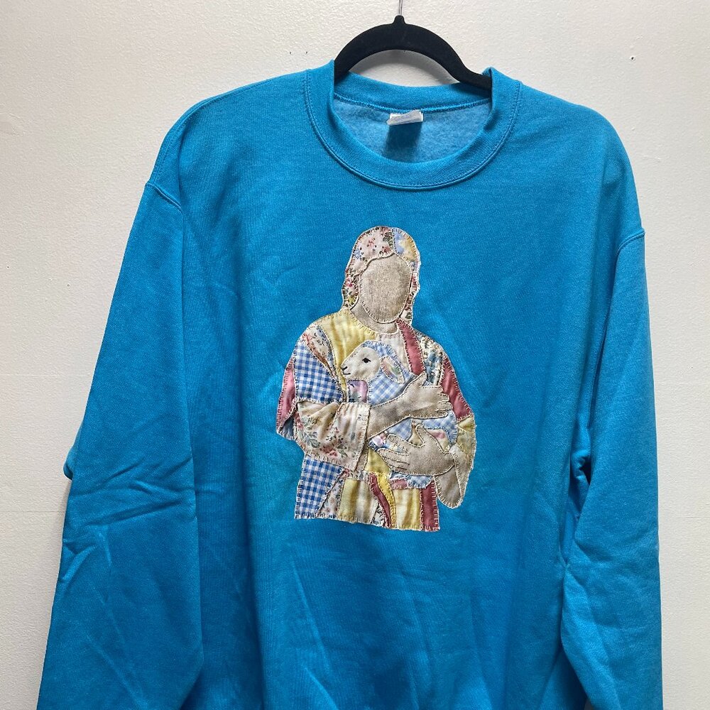 Port & Company blue sweatshirt featuring an inspiring Jesus and Lamb patchwok.